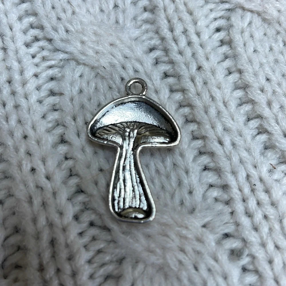 Mushroom silver toned pendent charm. 1.25” L x .75” wide. necklace or bracelet